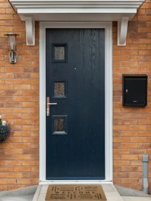 Navy blue composite front door with decorative glazed panels, fitted by Secura Windows