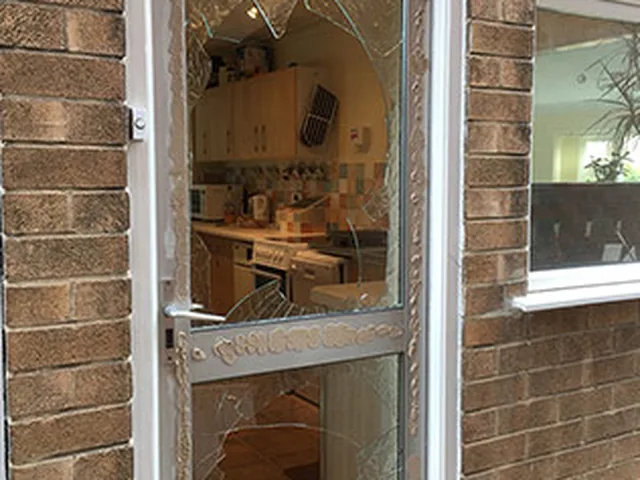 Damaged glazed door panel awaiting emergency repair by Secura Windows